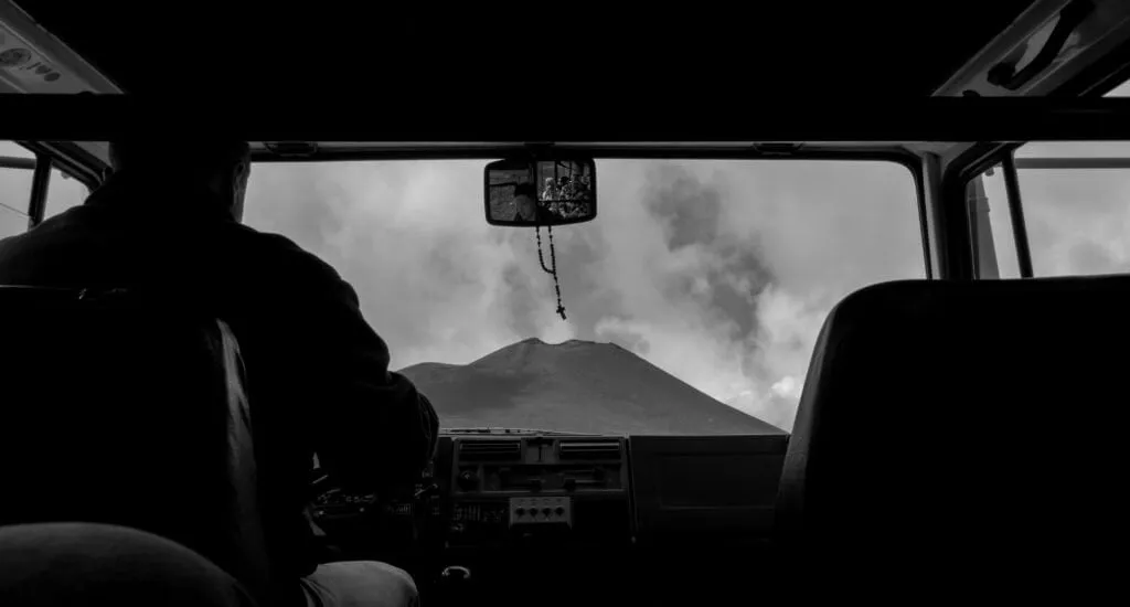 pair Etna framed through the windscreen of the summit shuttle jeep