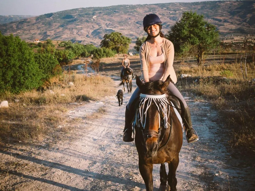 pair Riding out from the stables, farm dog alongside